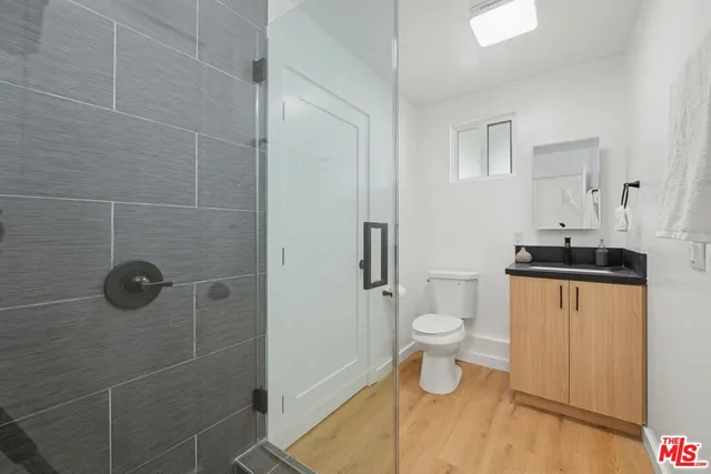 a bedroom with double bed and a wooden floor