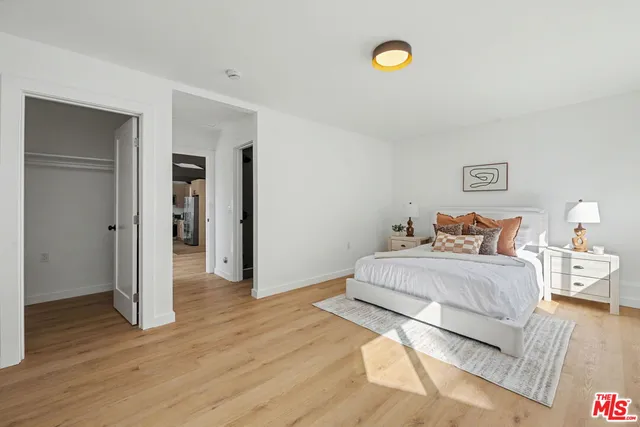 a bedroom with a bed and a couch