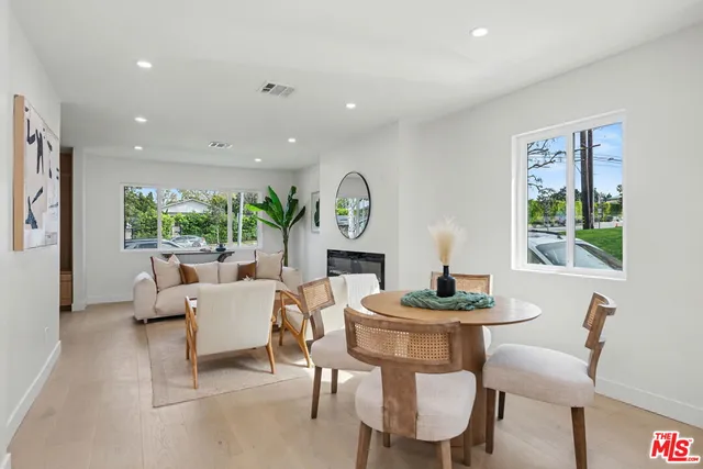 a living room with furniture a large window and a table