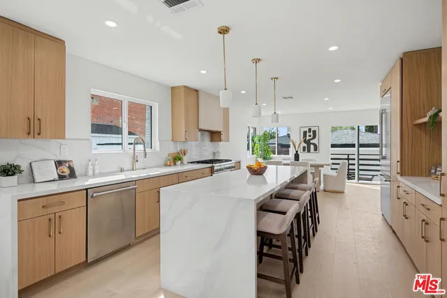 a kitchen with counter top space a sink appliances and cabinets