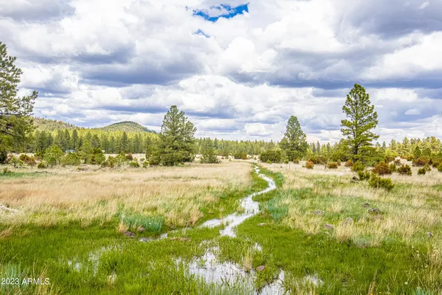 a view of an ocean with a building in the background