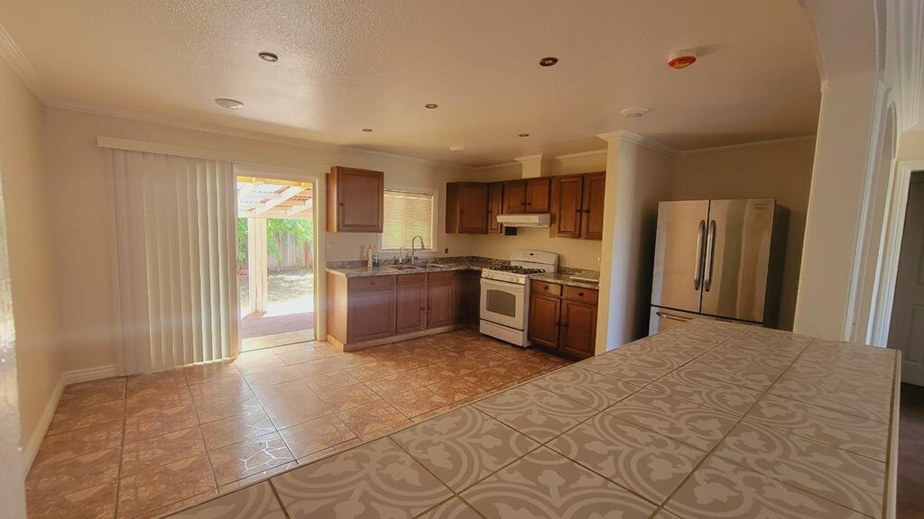 641 Brimmer Road Merced, CA 95341 - Photo 5 of 21 a large kitchen with cabinets and stainless steel appliances
