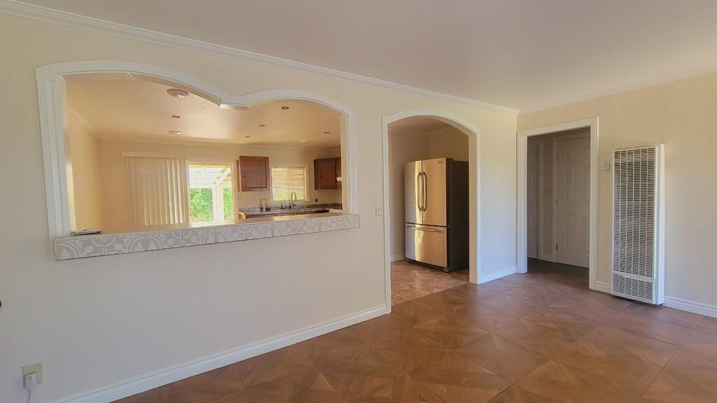 641 Brimmer Road Merced, CA 95341 - Photo 8 of 21 a view of a hallway with wooden floor and a living room