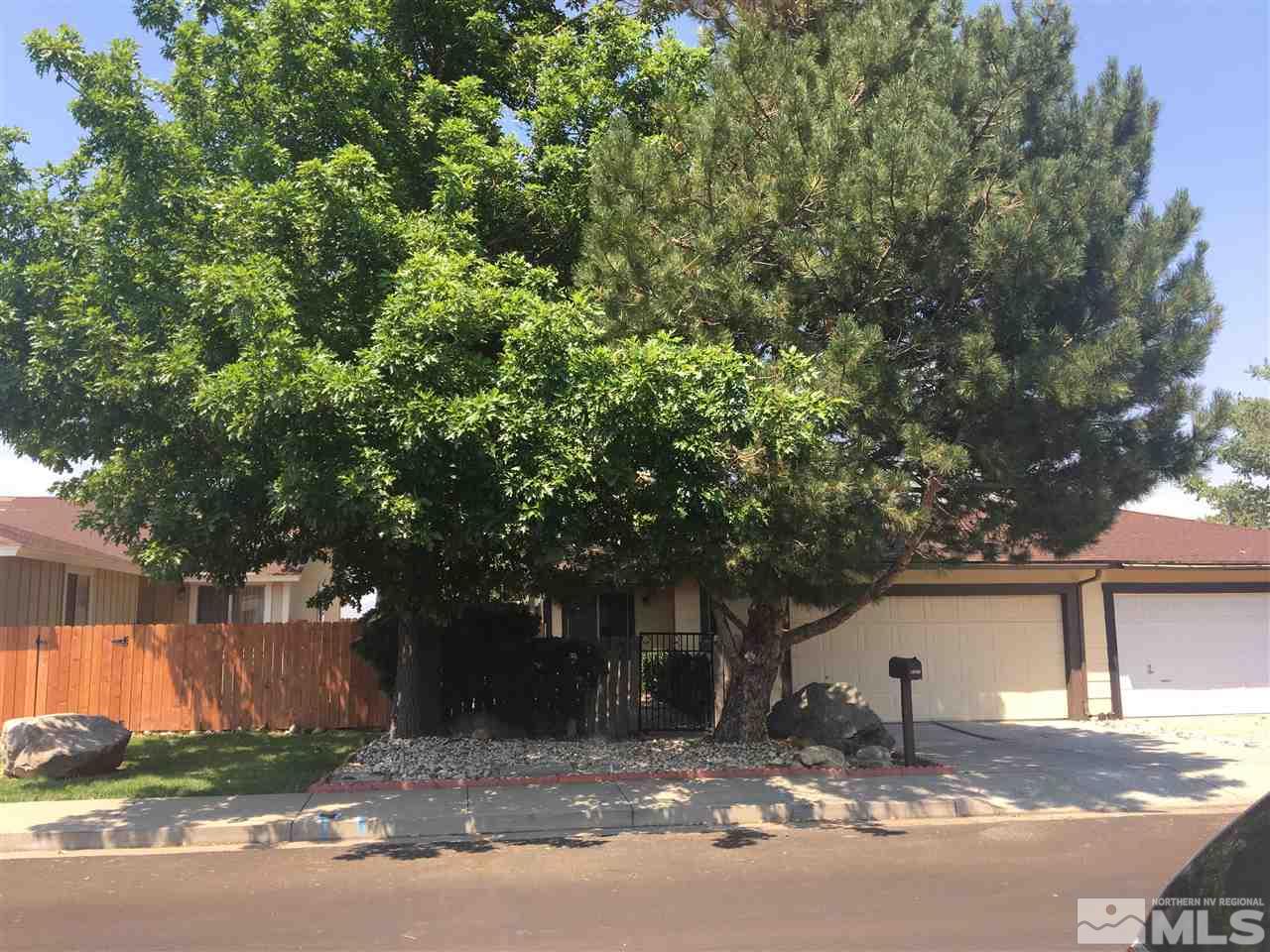 6655 Lotus Street Reno, NV 89506 - Photo 1 of 18 a tree in front of a white house