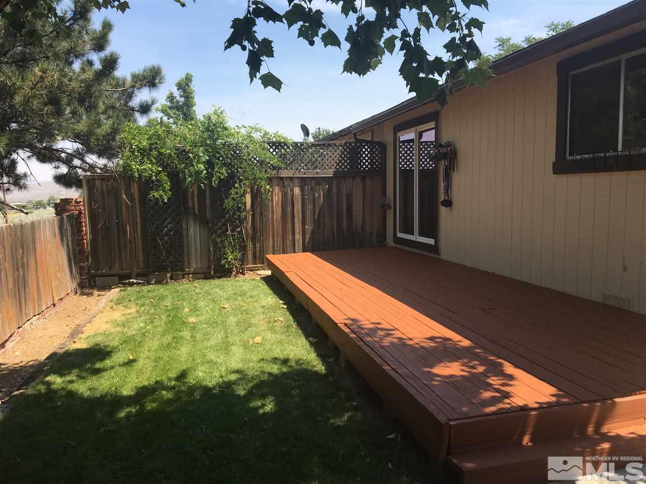 6655 Lotus Street Reno, NV 89506 - Photo 15 of 18 a view of a backyard with a large tree