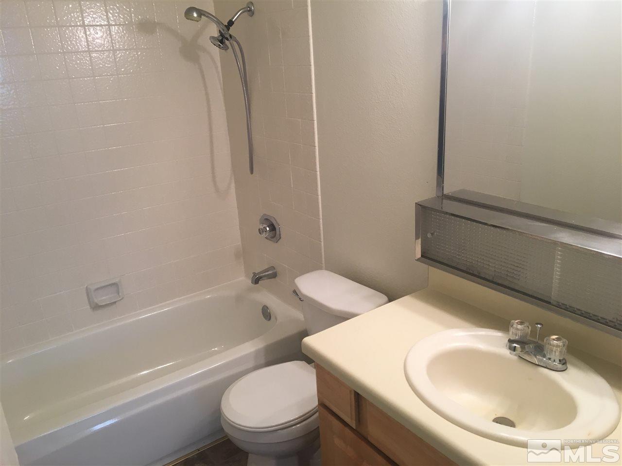 6655 Lotus Street Reno, NV 89506 - Photo 16 of 18 a bathroom with a sink a toilet and shower