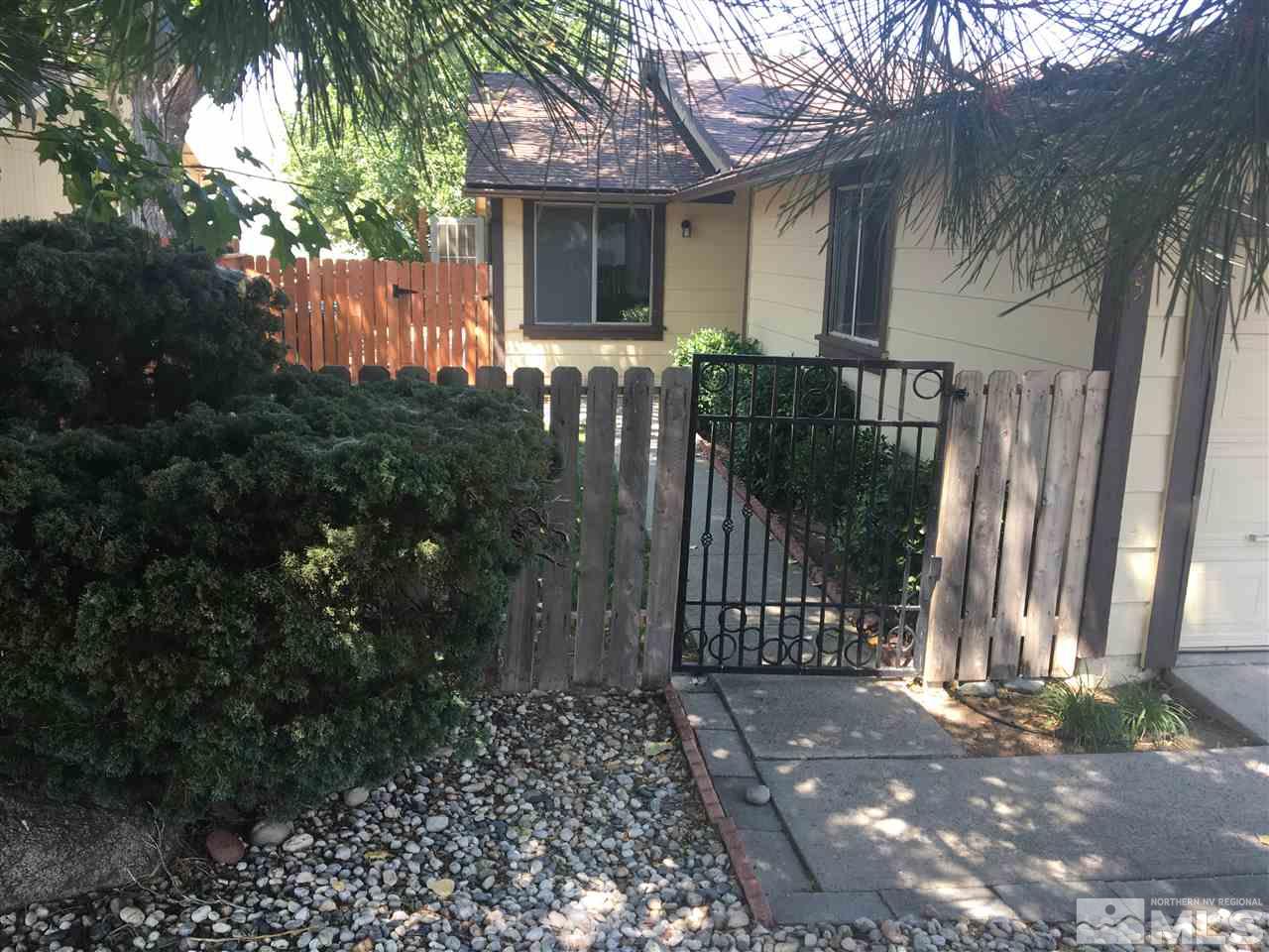6655 Lotus Street Reno, NV 89506 - Photo 2 of 18 a front view of a house with a garden