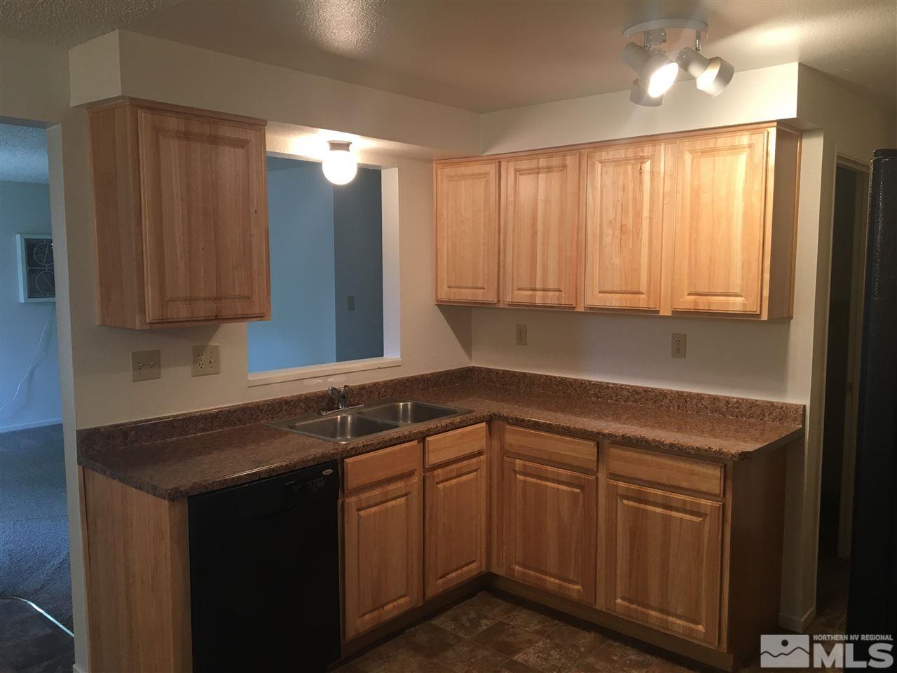 6655 Lotus Street Reno, NV 89506 - Photo 5 of 18 a kitchen with stainless steel appliances granite countertop cabinets and a sink