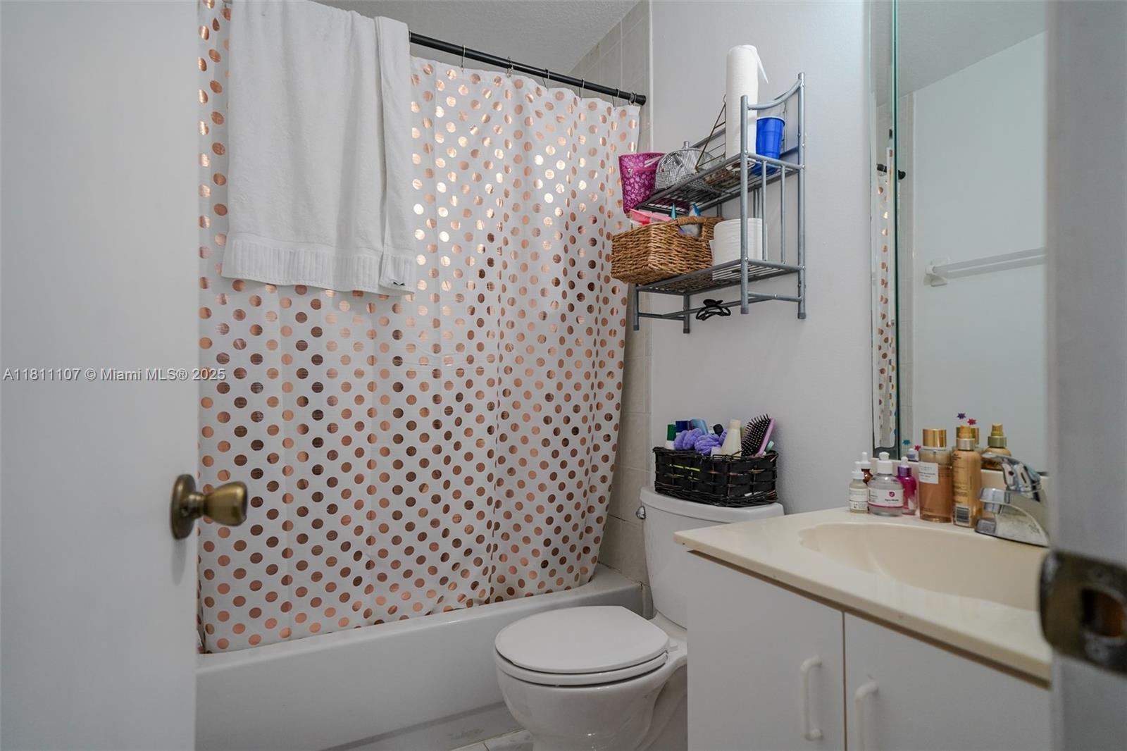 14816 Southwest 104th Street, Unit 85 Miami, FL 33196 - Photo 11 of 20 a bathroom with a sink a toilet and shower curtain