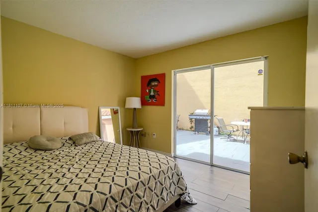 a bedroom with a bed and a large window