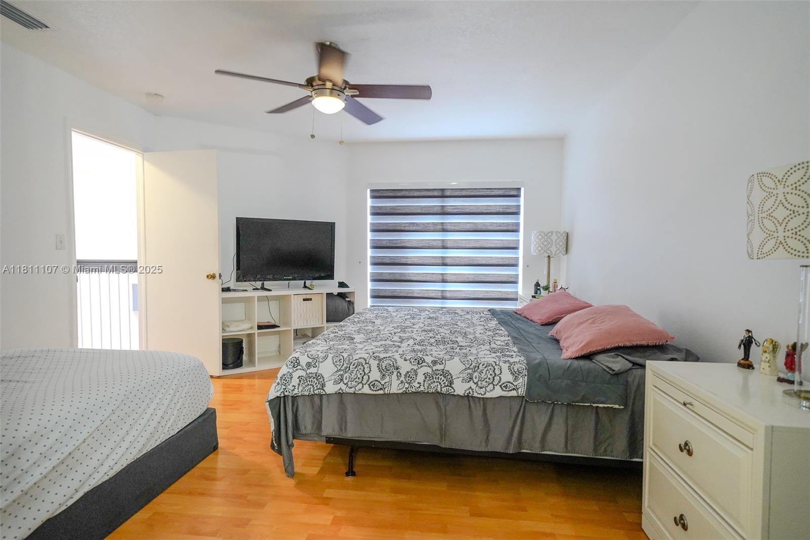 14816 Southwest 104th Street, Unit 85 Miami, FL 33196 - Photo 6 of 20 a bedroom with a bed and a flat screen tv