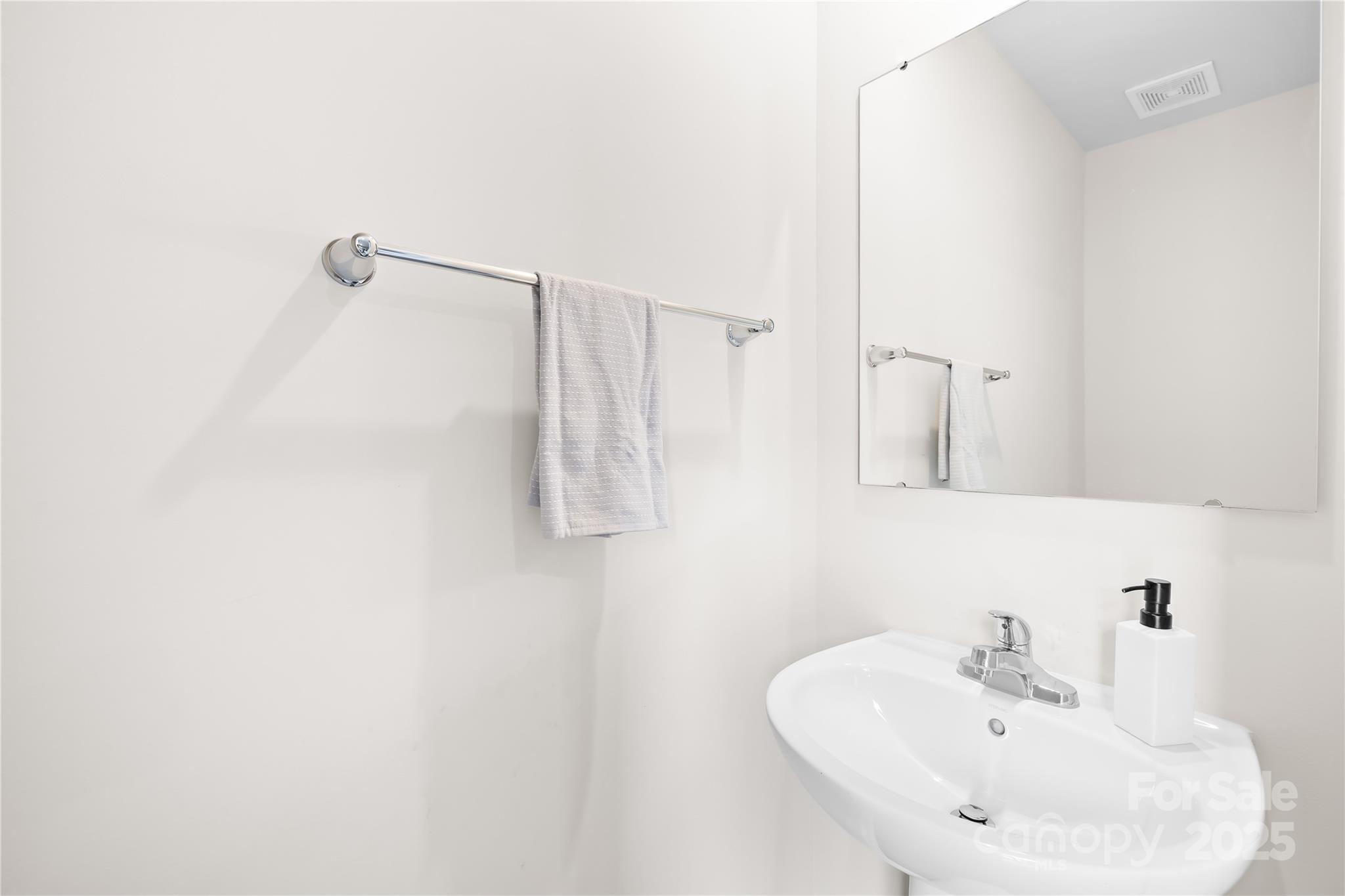 4447 Wild Rdg Drive Charlotte, NC 28215 - Photo 11 of 30 a bathroom with a sink a mirror and shower