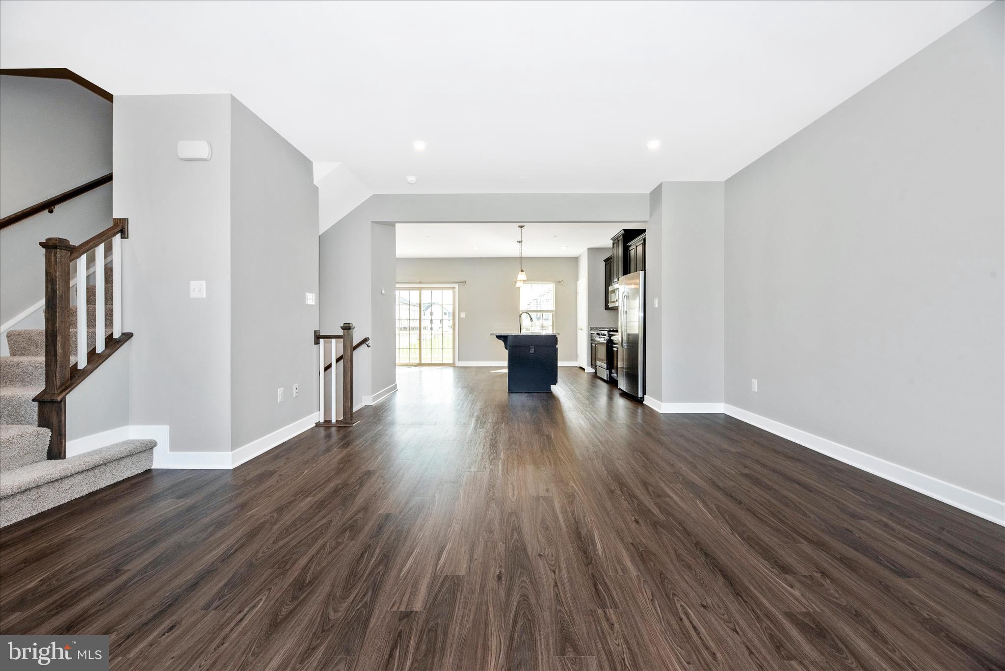 7091 Kokanee Way New Market, MD 21774 - Photo 10 of 69 a view of a big room with wooden floor and windows