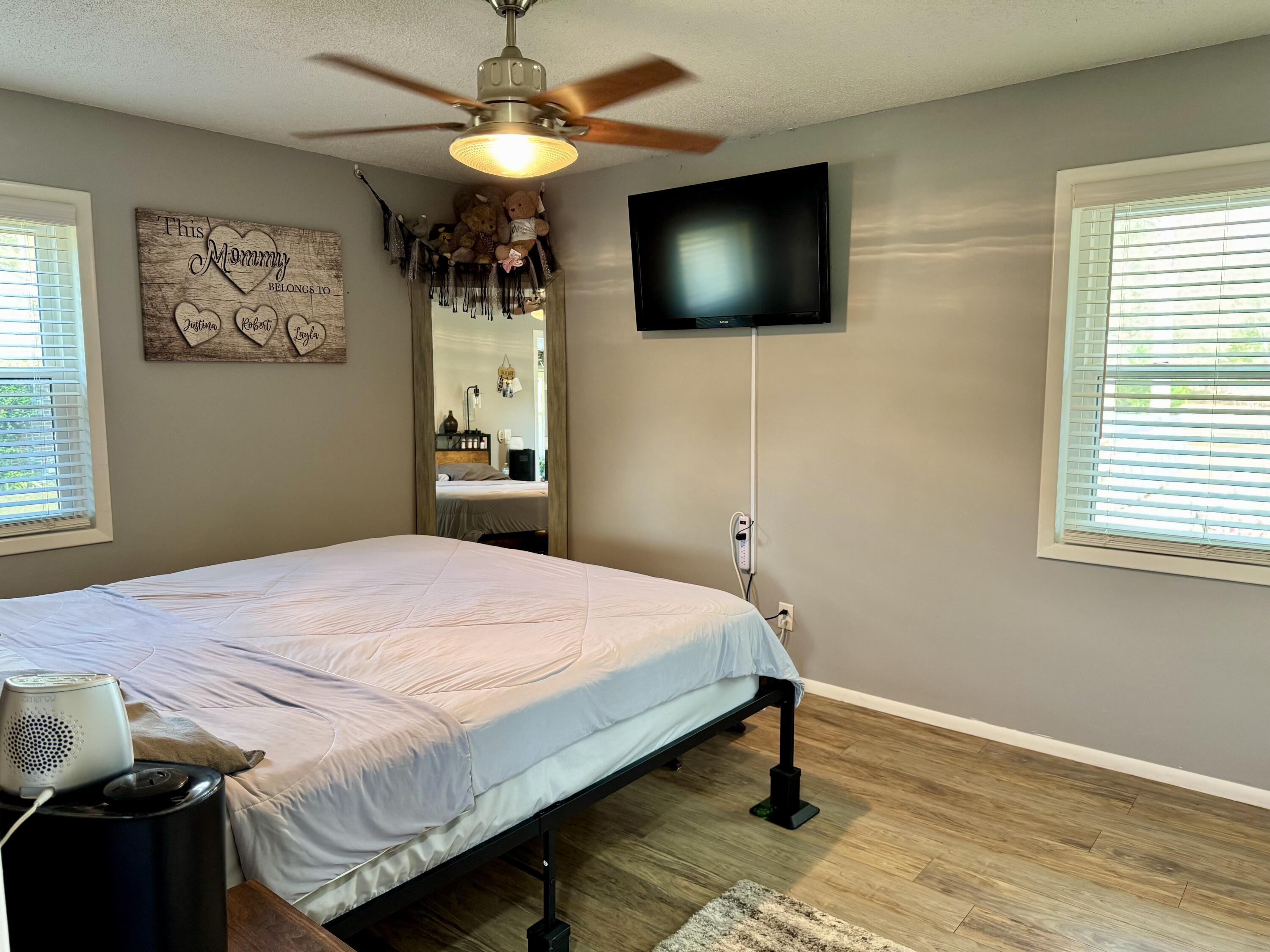 1133 Oak Avenue Elba, AL 36323 - Photo 11 of 26 a bedroom with a bed and a flat screen tv