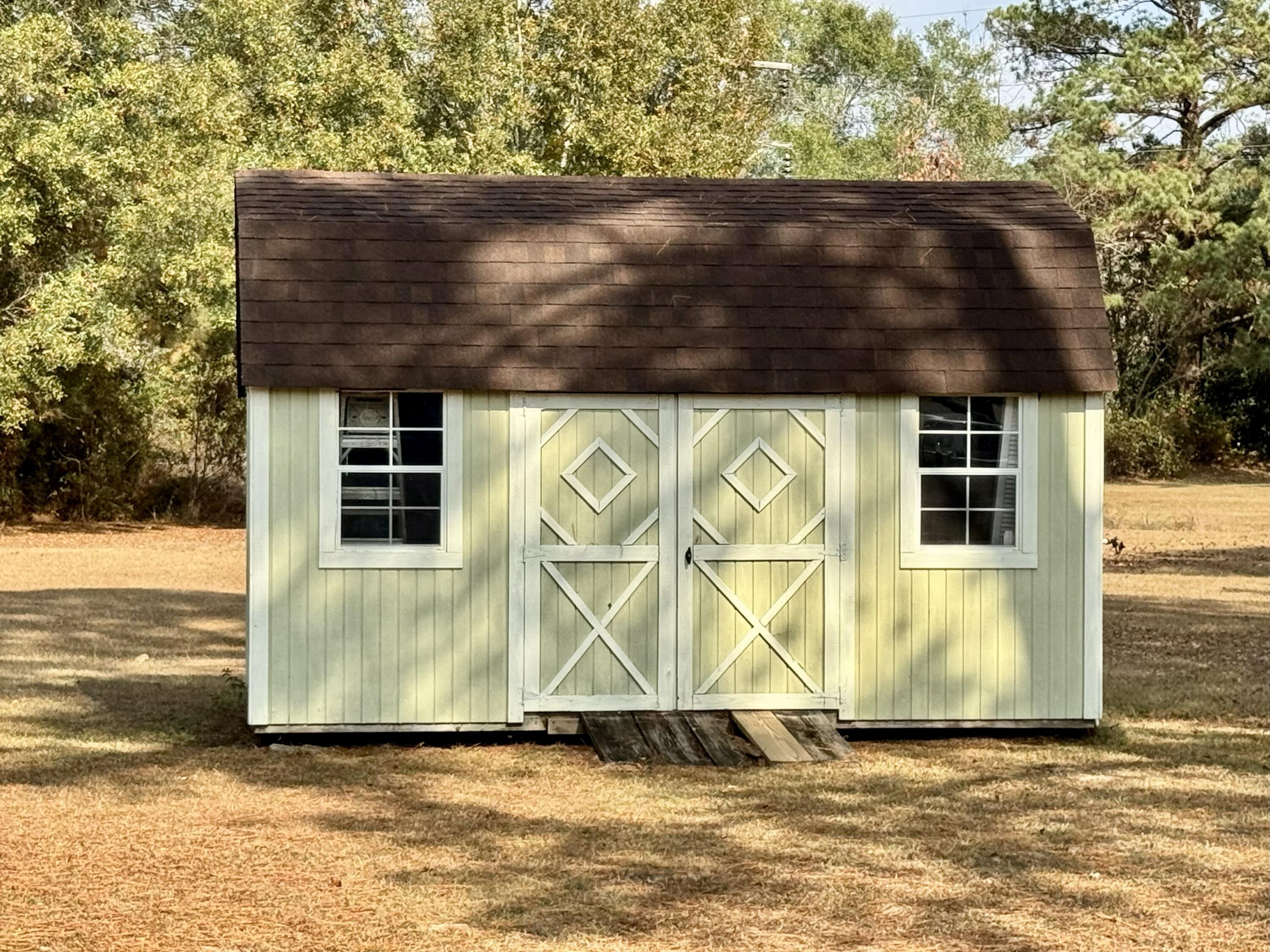 1133 Oak Avenue Elba, AL 36323 - Photo 20 of 26 a view of house with wooden floor and a large tree