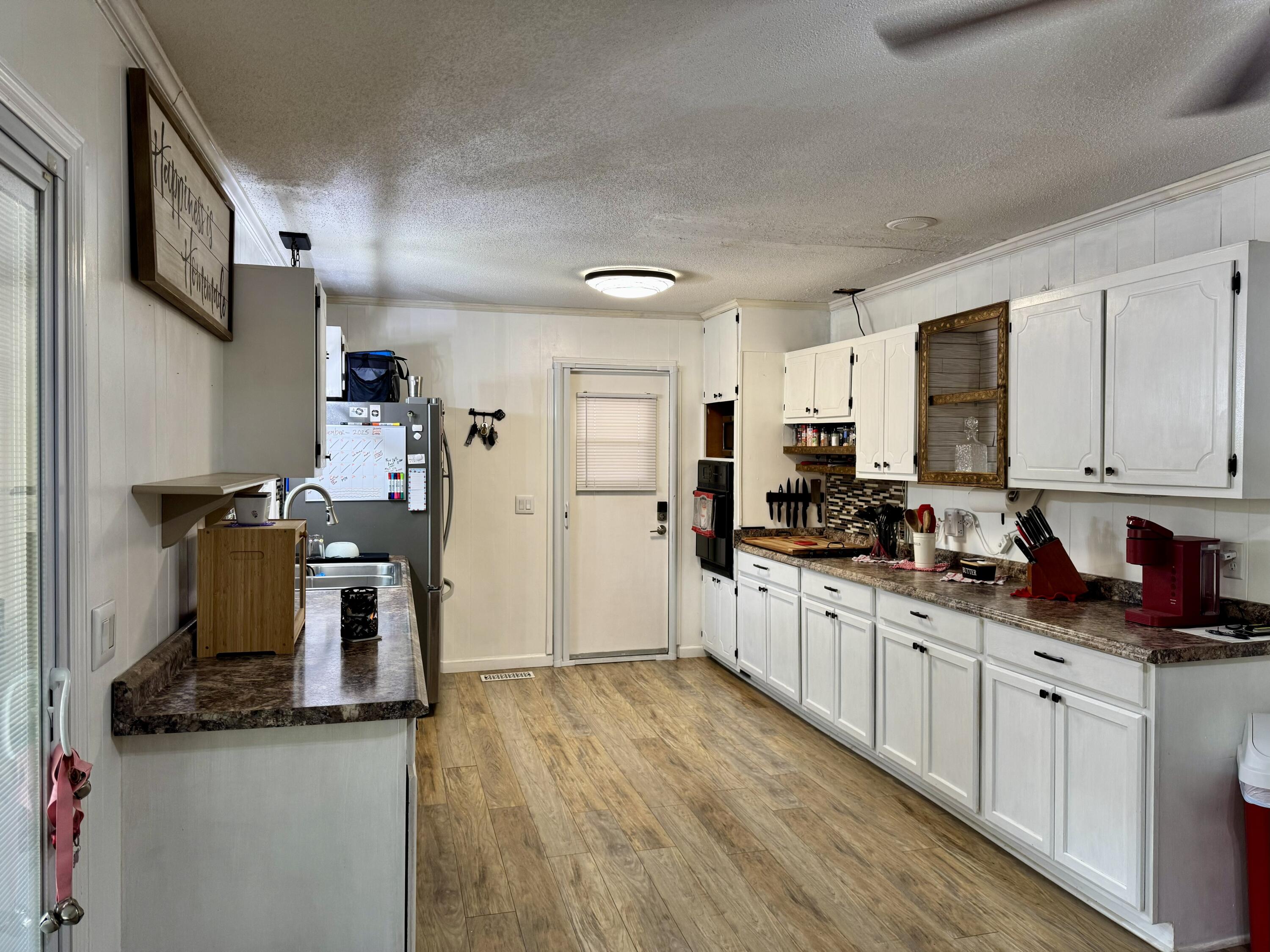 1133 Oak Avenue Elba, AL 36323 - Photo 6 of 26 a kitchen with stainless steel appliances granite countertop a sink stove and refrigerator