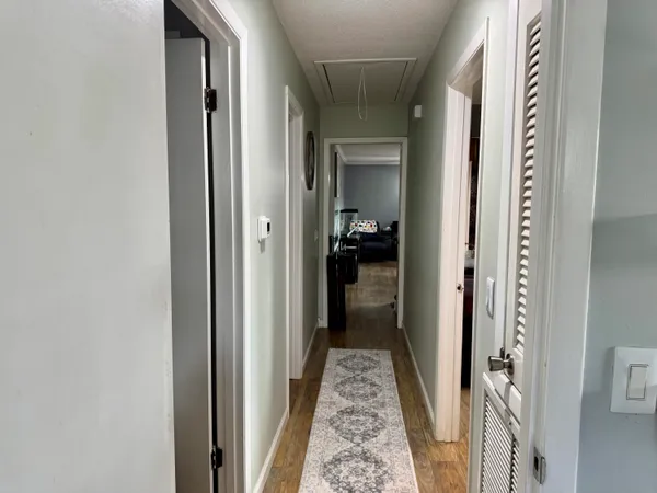 a view of a hallway with a wooden door