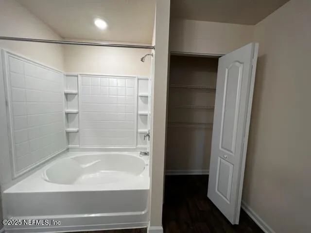 a bathroom with a bathtub and a shower