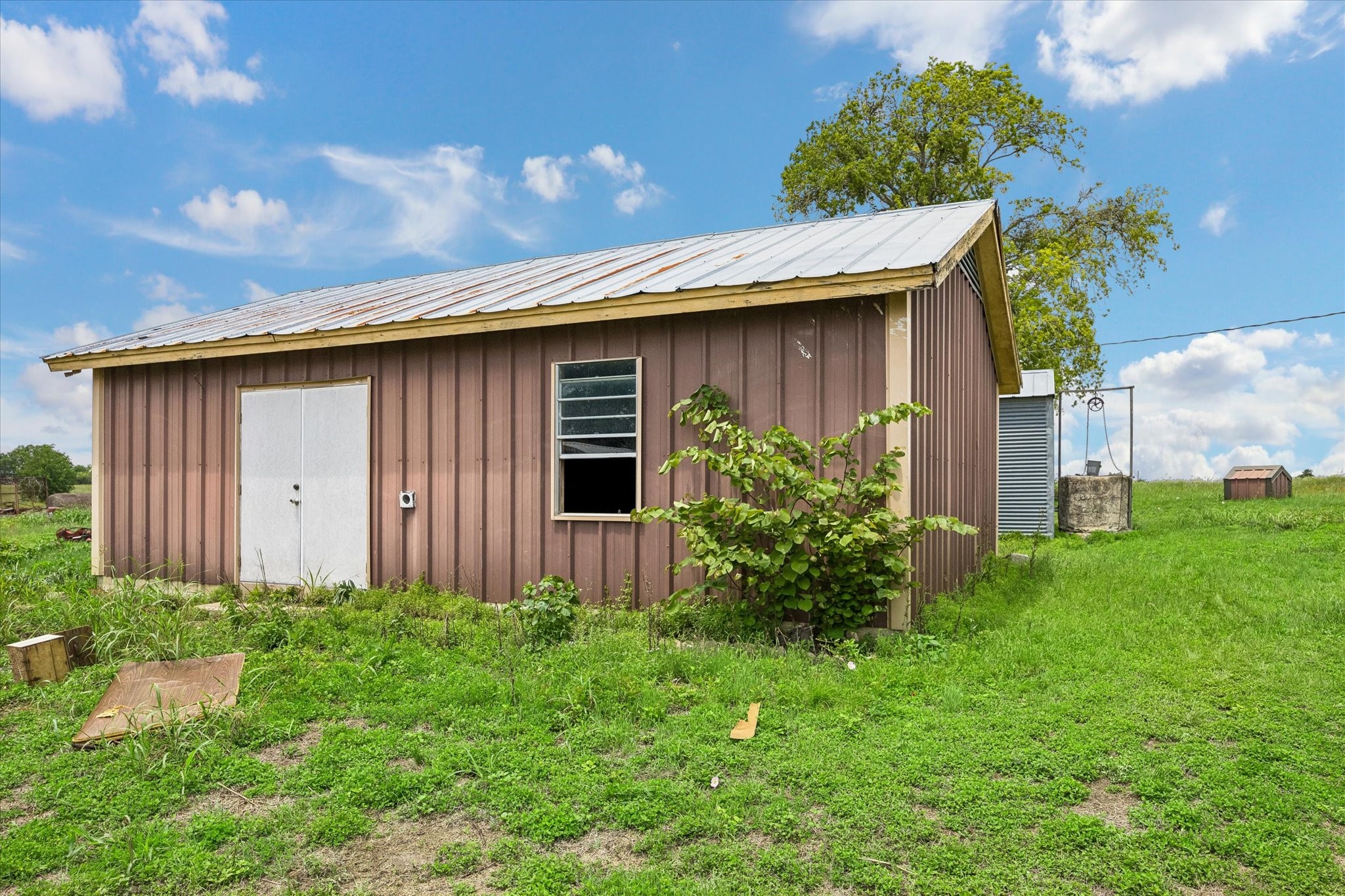 4754 Wickel Road Burton, TX 77835 - Photo 5 of 23 a house with a lot of plants in front of it