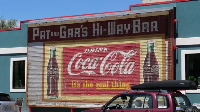 a view of a street with under a large tree