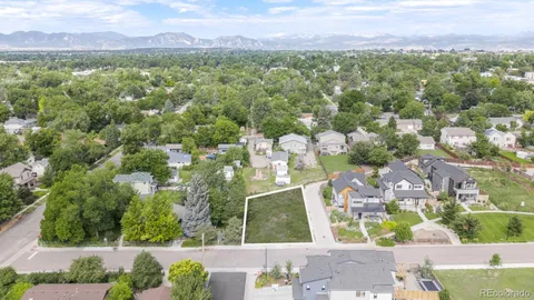 a view of a city with lush green forest