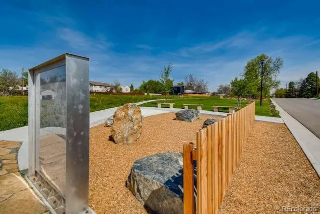a view of a garden with an outdoor seating