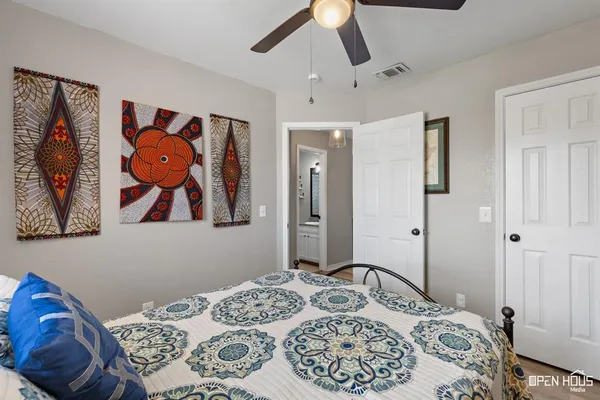 a bedroom with a bed and a painting on the wall
