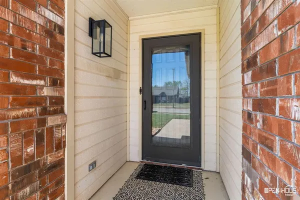 a view of a hallway with a door and wooden floor