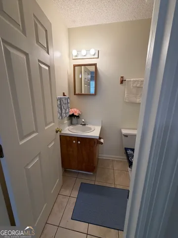 a bathroom with a sink a toilet a mirror and vanity