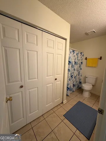 a view of a closet area with rug