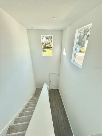 a view of a hallway with wooden floor