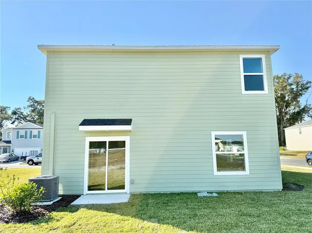 a view of house with backyard
