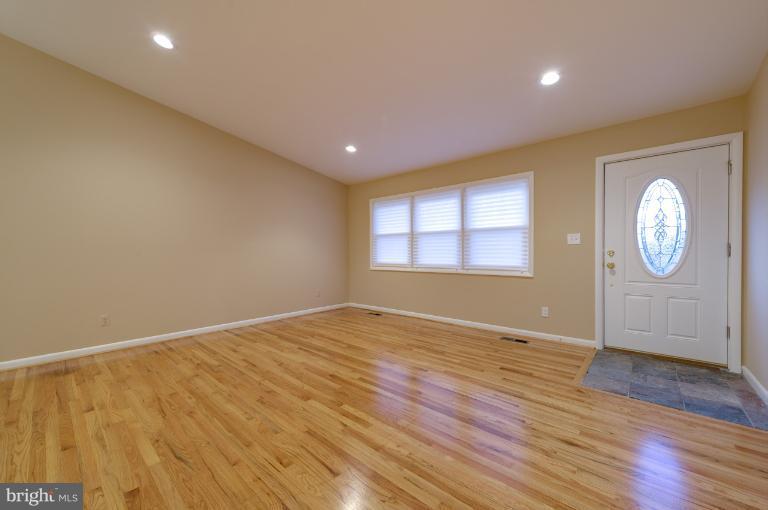 4748 Byron Road Windsor Mill, MD 21244 - Photo 11 of 27 a view of an empty room with window and wooden floor
