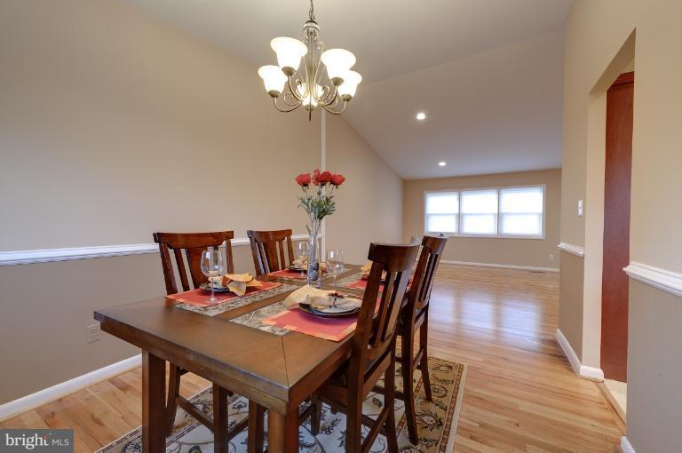 4748 Byron Road Windsor Mill, MD 21244 - Photo 16 of 27 a view of a dining room with furniture wooden floor and chandelier