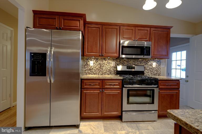 4748 Byron Road Windsor Mill, MD 21244 - Photo 17 of 27 a kitchen with stainless steel appliances granite countertop a refrigerator and a stove