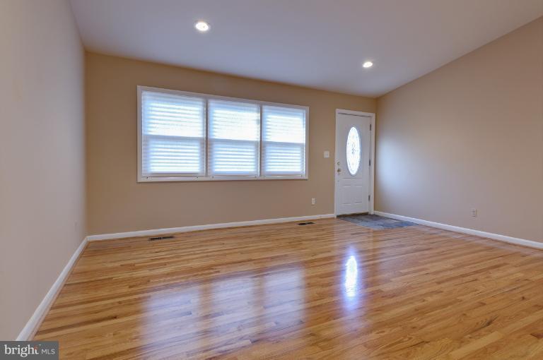 4748 Byron Road Windsor Mill, MD 21244 - Photo 18 of 27 an empty room with wooden floor and windows