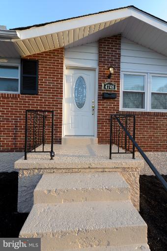 4748 Byron Road Windsor Mill, MD 21244 - Photo 21 of 27 a front view of a house with a garden