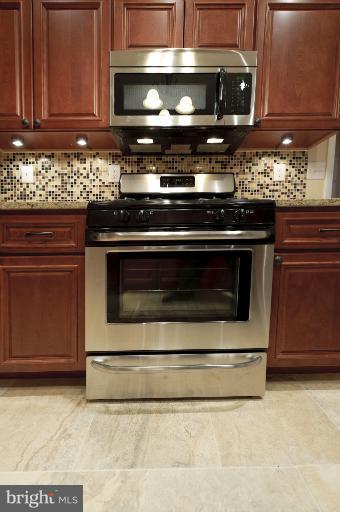 4748 Byron Road Windsor Mill, MD 21244 - Photo 7 of 27 a stove top oven sitting inside of a kitchen