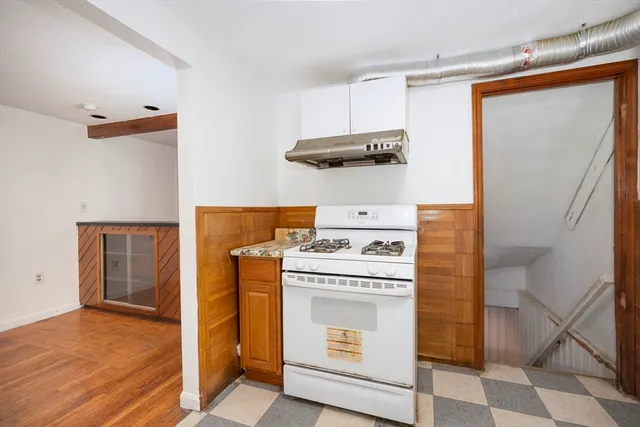 a kitchen with a stove and a refrigerator