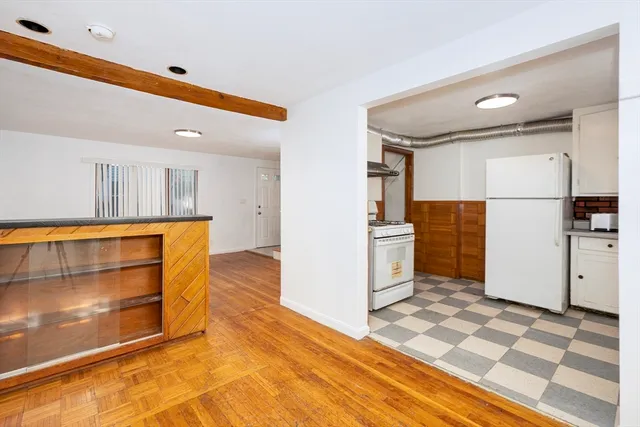 a kitchen with a refrigerator and a stove top oven