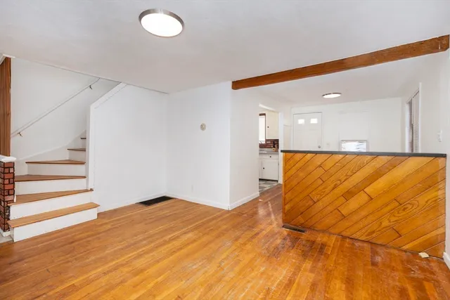 a view of a room with wooden floor and staircase
