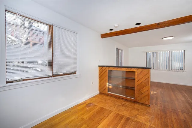 a view of room with window and wooden floor