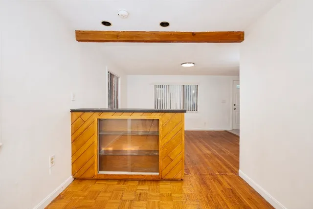 a view of a room with wooden floor