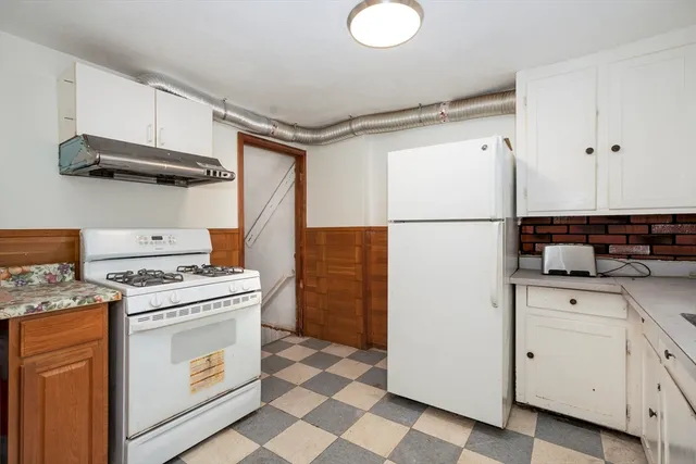 a kitchen with a stove a sink and a refrigerator