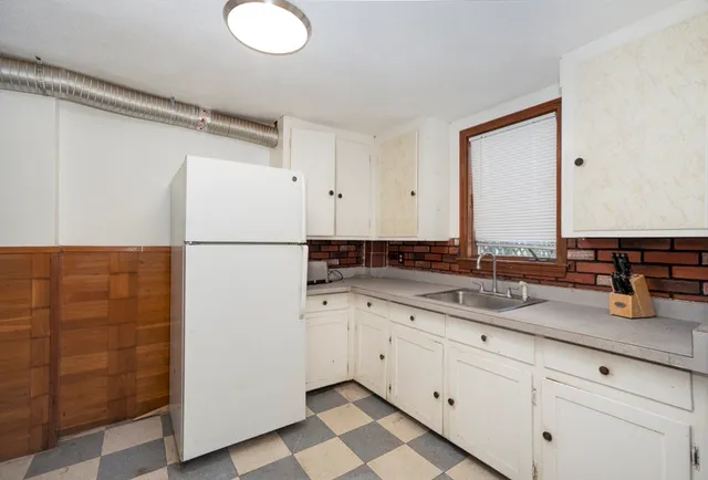 a kitchen with a sink and a refrigerator