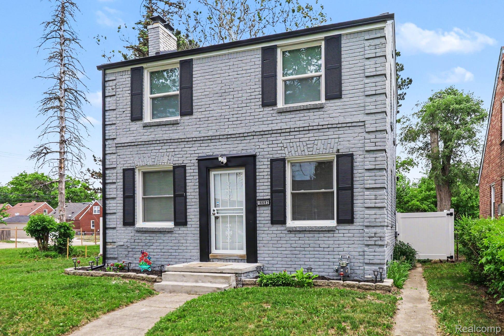 16682 Robson Street Detroit, MI 48235 - Photo 3 of 19 Two-story brick exterior featuring a painted finish and black shutters