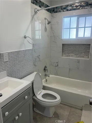 a bathroom with a sink a toilet and a bathtub