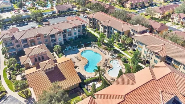 an aerial view of residential houses with outdoor space