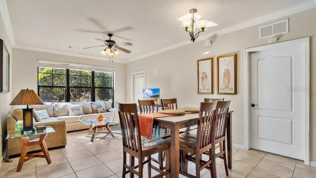 a view of a dining room with furniture a chandelier and wooden floor
