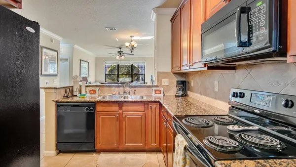 a kitchen with stainless steel appliances granite countertop a stove and a sink